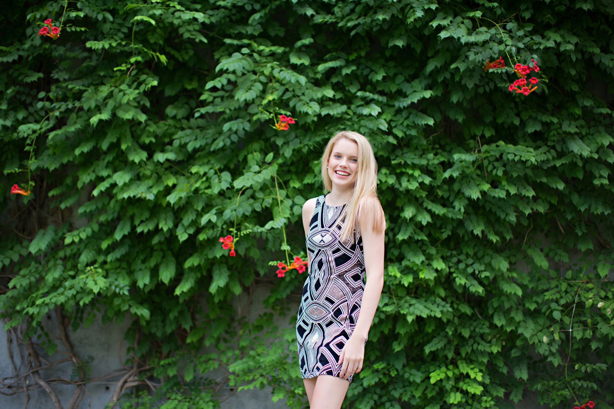 Girl posing in front of greenery wearing color-shifting dress