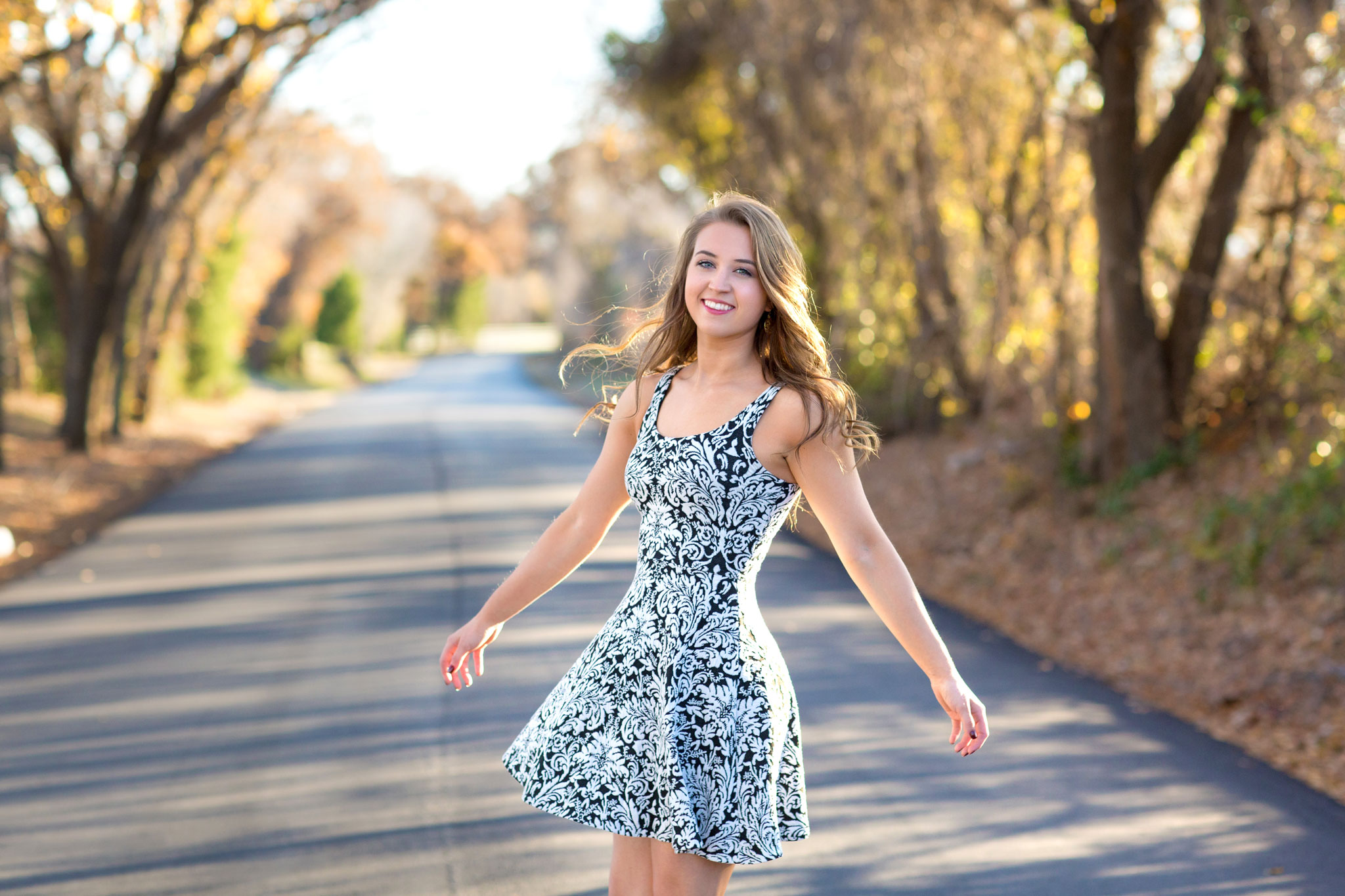 Girl wearing dress and posing on a road